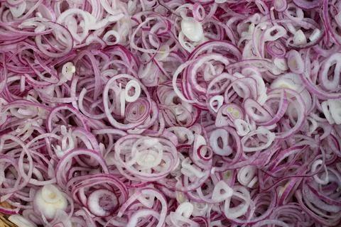Onion slices spread as background  Stock Photos