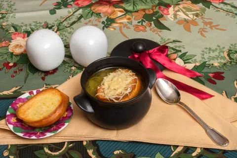 Onion soup on decorated table with eggs Stock Photos