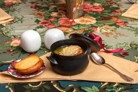 Onion soup on decorated table with eggs Stock Photos