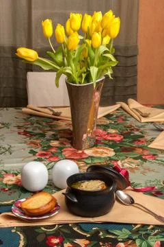 Onion soup on decorated table with eggs Stock Photos