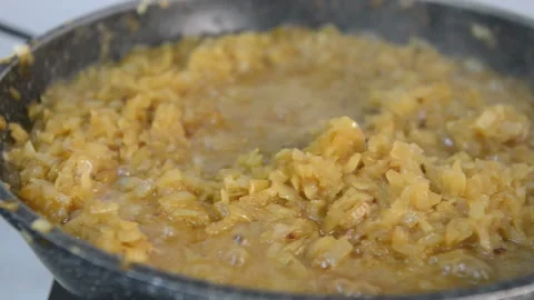 Onion stewing in a pan Stock Footage 131858486