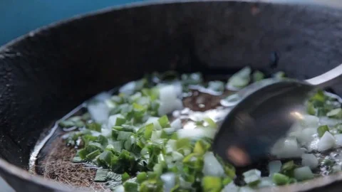 Onion stir a spoon in a pan Stock Footage 71710830