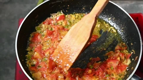 Onion, Tomato, chilli and sauce in hot oil on pen. Slow motion video Stock Footage 203476977