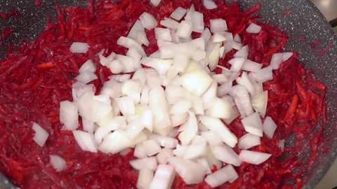 Onions and beetroot are fried in a frying pan Stock Footage 255125717
