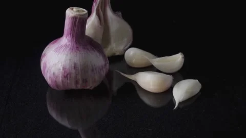 Onions and Garlic Falling on Black Background Dramatic Food Still Life Stock Footage 334563074