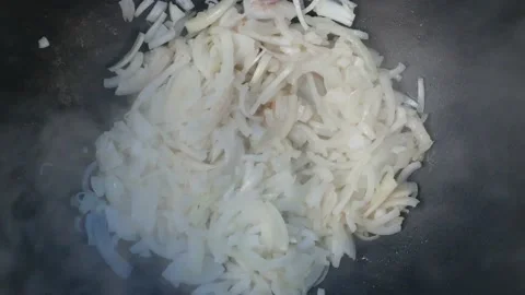 Onions are fried in a cauldron on the stake, view of Stock Footage 168621572