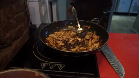 Onions are fried in a frying pan Stock Footage 159881253