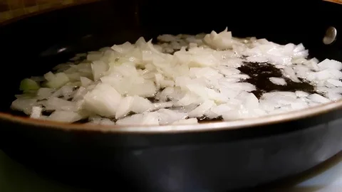 Onions are fried in a pan Video stock 80500834