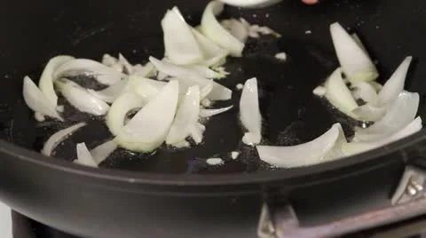Onions being fried and curry paste being stirred in Video stock 24672664