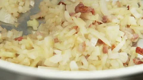 Onions being fried with diced bacon Stock Footage 24638396