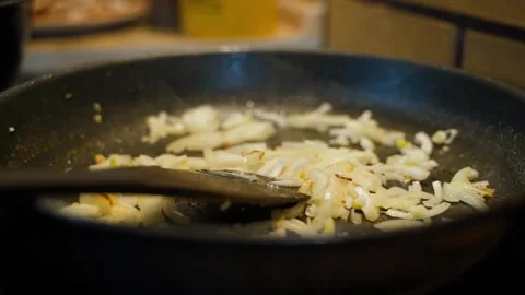 Onions being fried in a pan, close-up Stock Footage 309544406