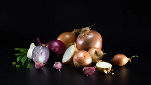 Onions on black background, panning 스톡 동영상 75736944
