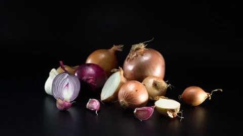Onions on black background, panning Video stock 75737470