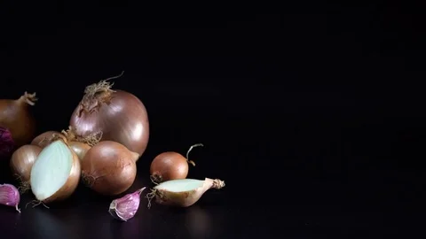 Onions on black background, sliding Video stock 75737434