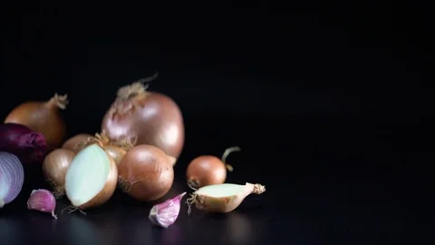 Onions on black background, sliding, shallow Depth of field Video stock 75866463