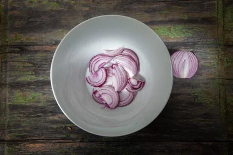 Onions Cut with Half Setup on White Plate Stock Photos