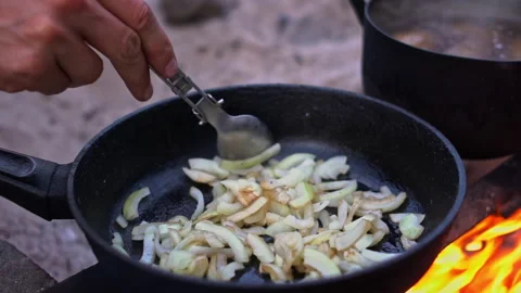 Onions frying over fire Stock Footage 284248344