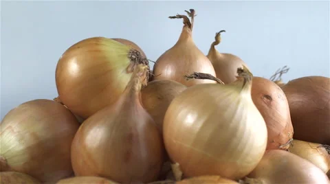 Onions isolated rotating on gray background Stock Footage 62385817