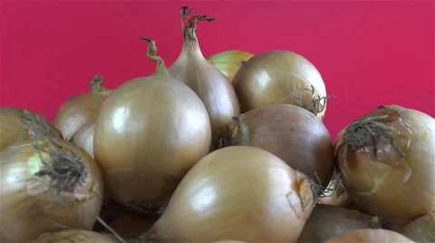 Onions isolated rotating on red background Stock Footage 62388065