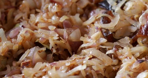 Onions pan fried with bacon rotating, close-up Stock Footage 121310267
