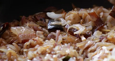 Onions pan fried with bacon rotating, close-up Stock Footage 121323077