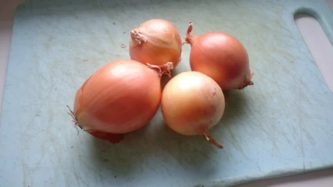 Onions on a plastic board Stock Footage 86790092