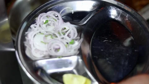 Onions on a plate in India Stock Footage 132580756
