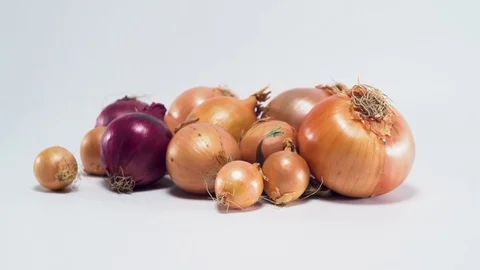Onions on white background, panning Video stock 75810623