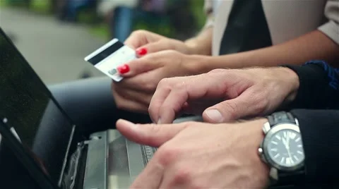 Online banking with a laptop. Male and female hands Stock Footage