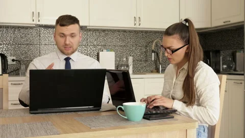 Online business.Young married couple working at home. Spouses argue. Stock Footage 129694553