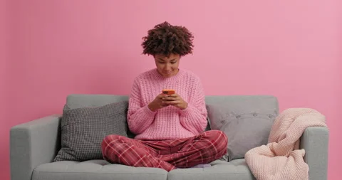 Online chatting. Serious dark skinned young woman concentrated in smartphone Stock Footage 144059069