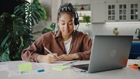 Online courses concept. Young smart black lady student wearing headset video Stock Footage 197574971