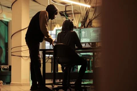 Online criminals analyzing script codes to hack government system Stock Photos