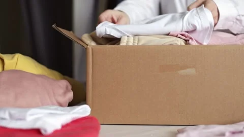 Online delivery of clothes on customer orders, fashion items in a parcel in a 스톡 동영상 169349174