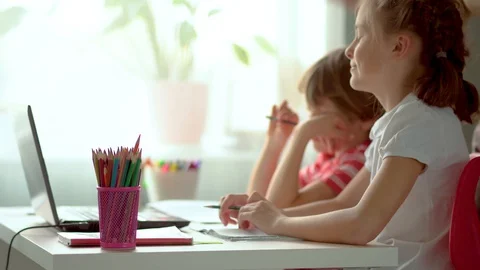 Online distance learning for children. Son and daughter use a laptop for Stock Footage 129666072
