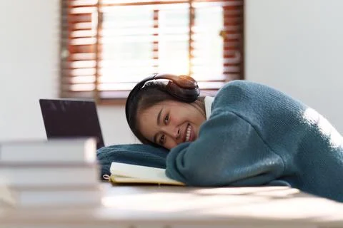 Online education, e-learning. Asian woman relaxing after studying using a laptop Stock Photos