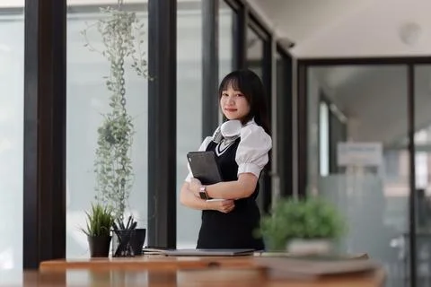 Online education, e-learning. Asian woman in stylish casual clothes, studying Stock Photos