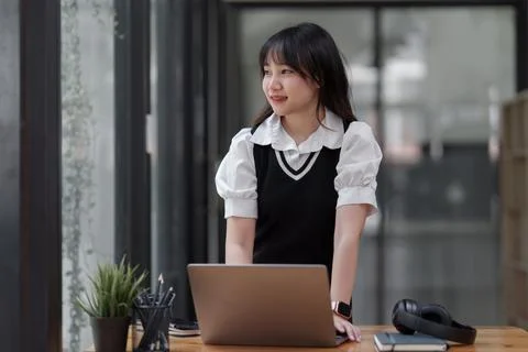 Online education, e-learning. Asian woman in stylish casual clothes, studying Stock Photos