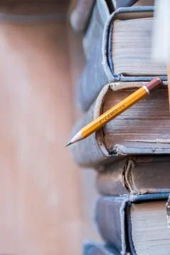 Online education, e-learning concept. inscription on a pencil and vintage books. Stock Photos