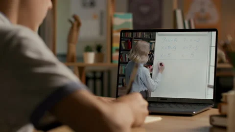 Online education of smart child using laptop at evening home. Remote study of li Stock Footage 199484778