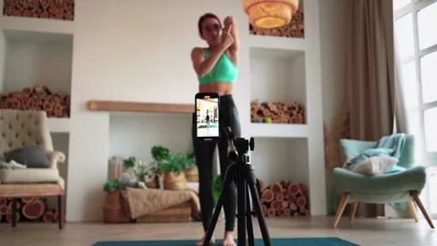 Online learning and live streaming Woman blogger fitness filming on phone camera Stock Footage 150047285