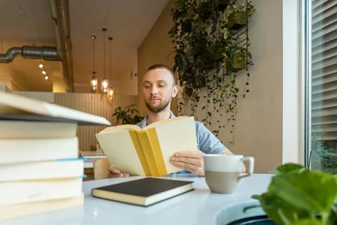 Online learning and reading in a modern workspace with plants and books 写真素材