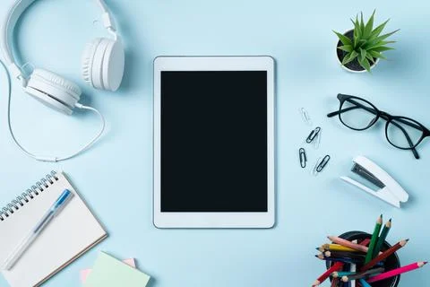 Online learning design concept. Table with tablet, headphone and stationeries Stock Photos