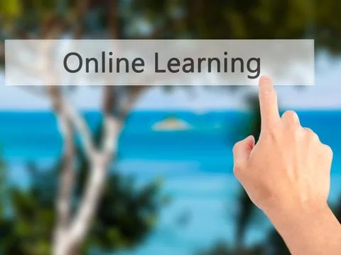 Online Learning - Hand pressing a button on blurred background concept on vis Stock Photos
