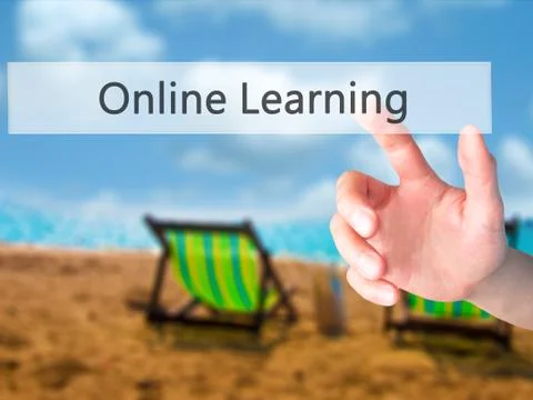 Online Learning - Hand pressing a button on blurred background concept on vis Stock Photos