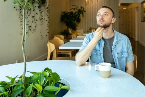 Online learning moment while sipping coffee in a modern workspace with plan.. Stock Photos