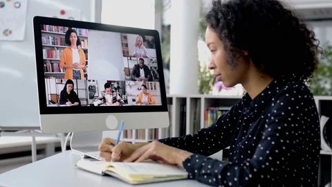 Online learning. Smart african american curly girl, sits at a desktop in front Stock Footage 195127149