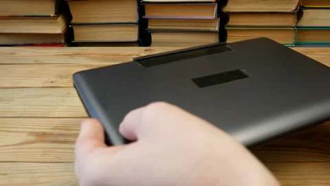 Online learning, studing and teaching concept, books pile and laptop, remote  Stock Footage 130440914