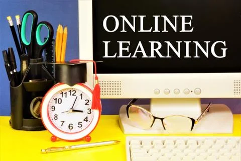 Online learning. Text message on the computer monitor. Stock Photos