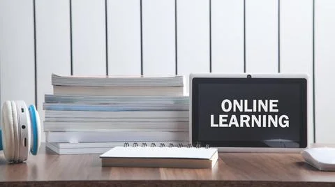 Online Learning text in tablet screen with a business objects. Stock Photos